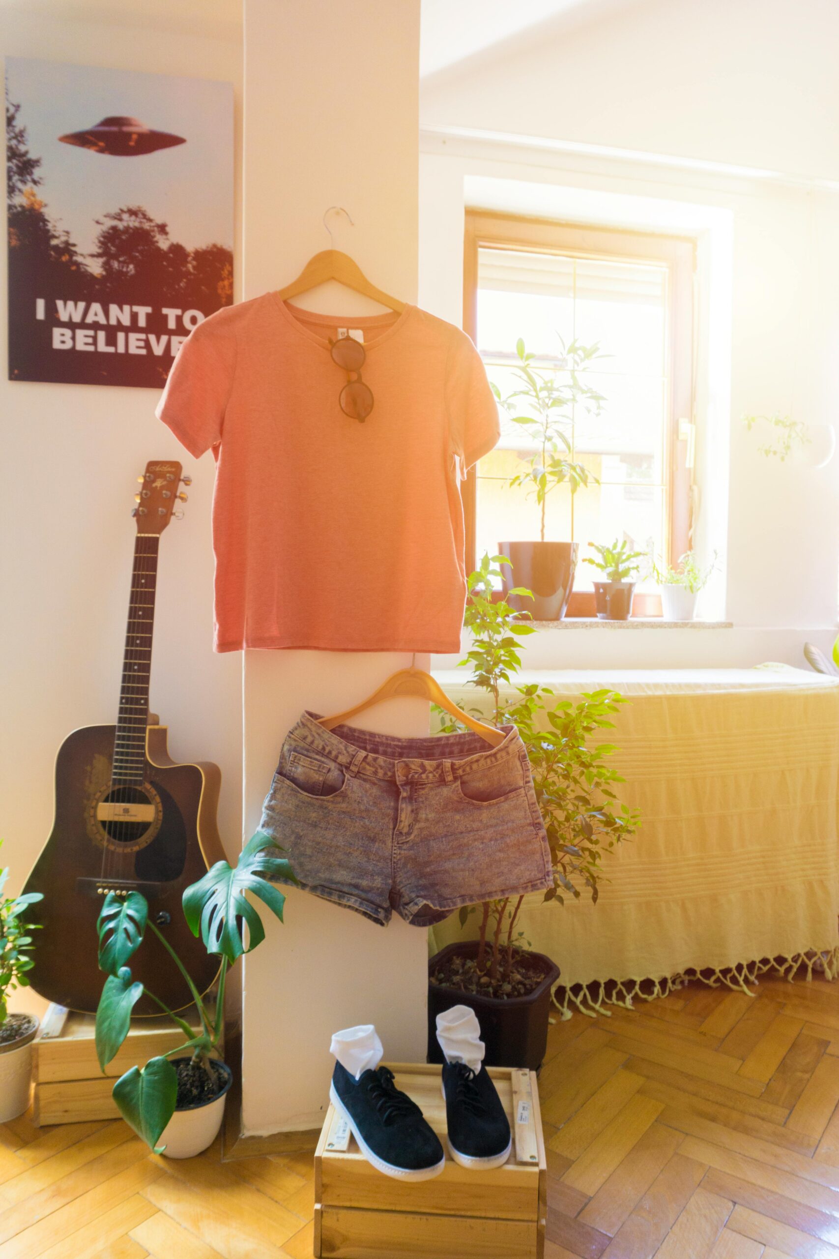 Warm and inviting living space featuring casual wear, guitar, and indoor plants.